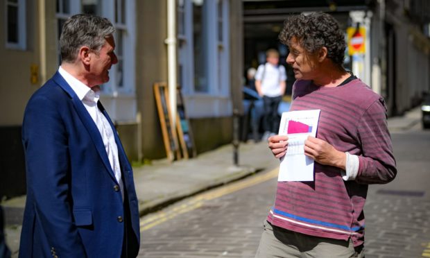 Sir Keir Starmer is confronted by Rod Humphris (right), landlord of The Raven pub in Bath