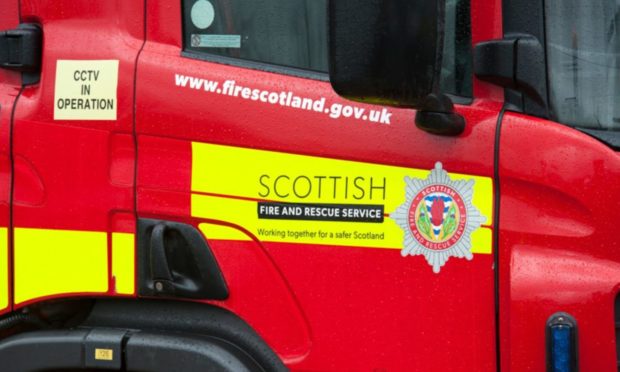 Firefighters were seen battling to control the flames, which were "well established" through the car when they arrived at the scene, south of Fyvie.