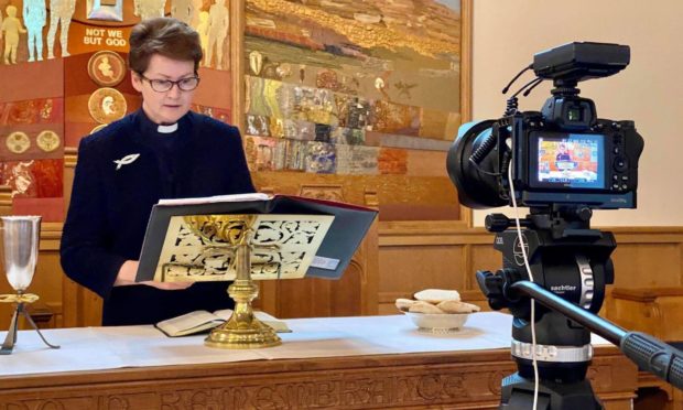 Rev Maggie McArthur minister of Cardross Parish Church in Dunbartonshire, records an online service.