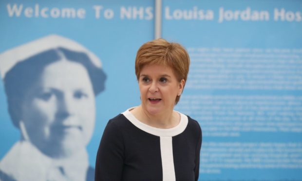 First Minister Nicola Sturgeon during a visit to the NHS Louisa Jordan at the SEC, Glasgow, to learn about the venue being adapted for treating outpatients. PA Photo. Picture date: Monday July 27, 2020. See PA story SCOTLAND Coronavirus. Photo credit should read: Andrew Milligan/PA Wire