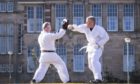 Scottish Liberal Democrat Leader Willie Rennie (right) takes part in a karate lesson with Robert Steggles at The Meadows, Edinburgh, during campaigning for the Scottish Parliamentary election today.
