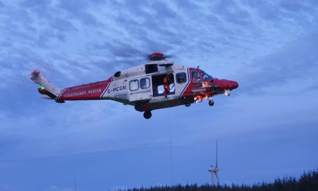 The Coastguard helicopter winching the casualty to safety