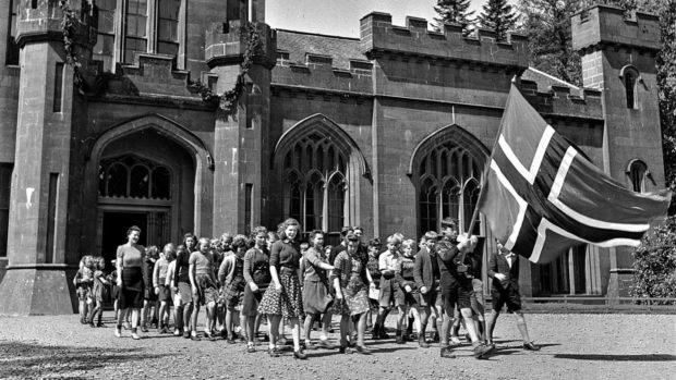 Norwegian children proudly march with their national flag at Drumtochty Castle - their refuge and school during the Second World War.