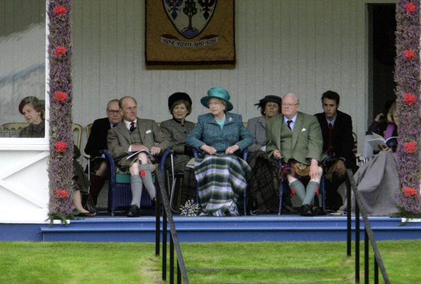 Prince Philip and the Queen watching the Braemar games. Pic by Raymond Besant.