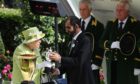 The Queen presents the sheikh with a trophy after his horse won the Diamond Jubilee Stakes at Royal Ascot in 2019.
