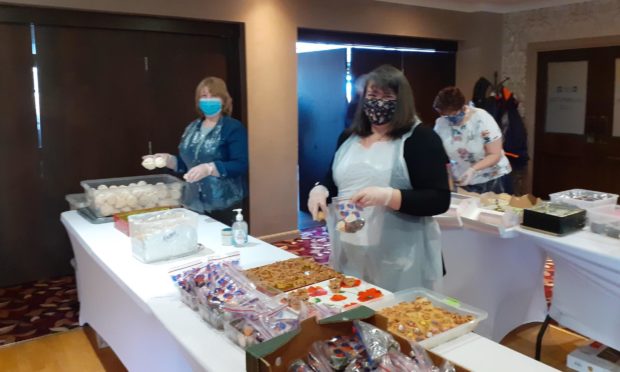 Volunteers preparing  afternoon teas to raise money for charity