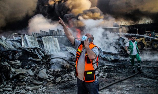 Crews of the Palestinian Civil Defence work at extinguishing a fire engulfing an agrochemical factory following an Israeli bombardment in Beit Lahia, in the northern Gaza Strip. Picture courtesy of Shutterstock.