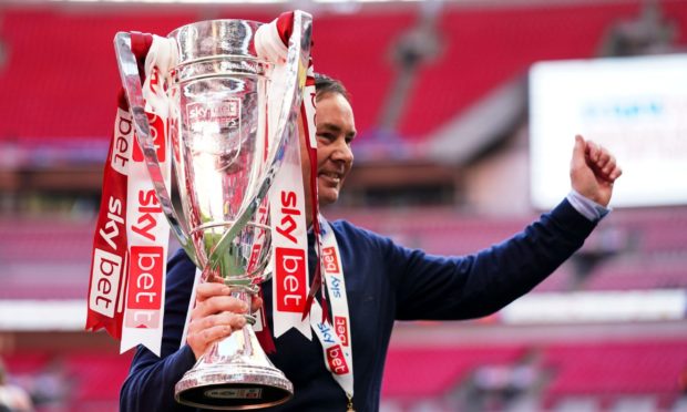 Morecambe boss Derek Adams with the League Two play-off trophy.