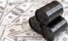 Barrels of oil against the background of American dollars. Sale of oil. Oil market.; Shutterstock ID 1295630341; Purchase Order: -