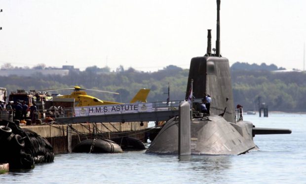 Emergency services surround the HMS Astute in 2011 after a shooting on board