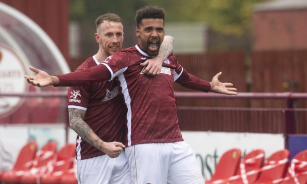Nathan Austin celebrates after completing his hat-trick against Brora Rangers.