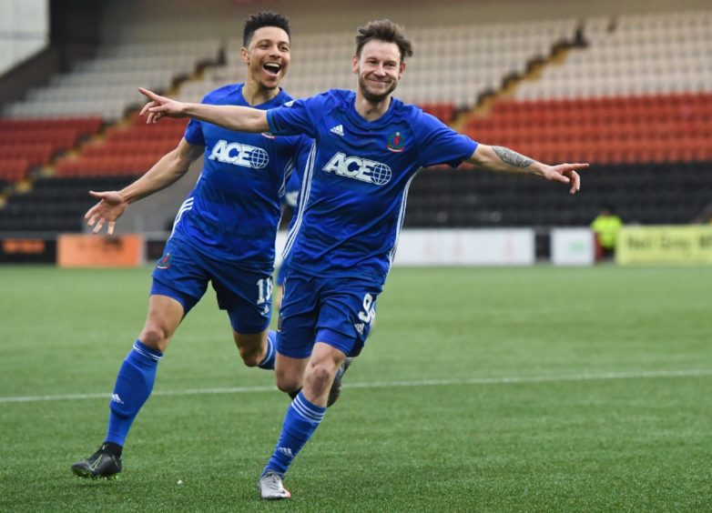 Cove's Mitch Megginson celebrates making it 1-0.