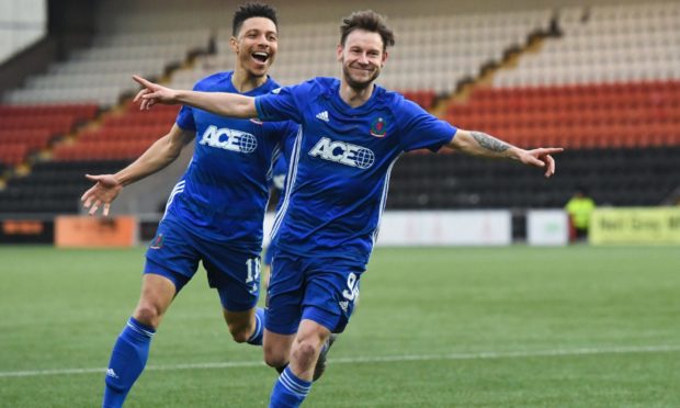 Cove's Mitch Megginson celebrates making it 1-0.