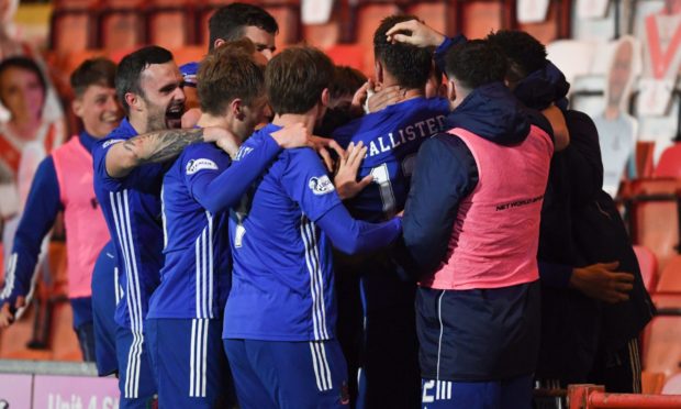 Cove's Rory McAllister (centre) celebrates making it 2-1 with his teammates.