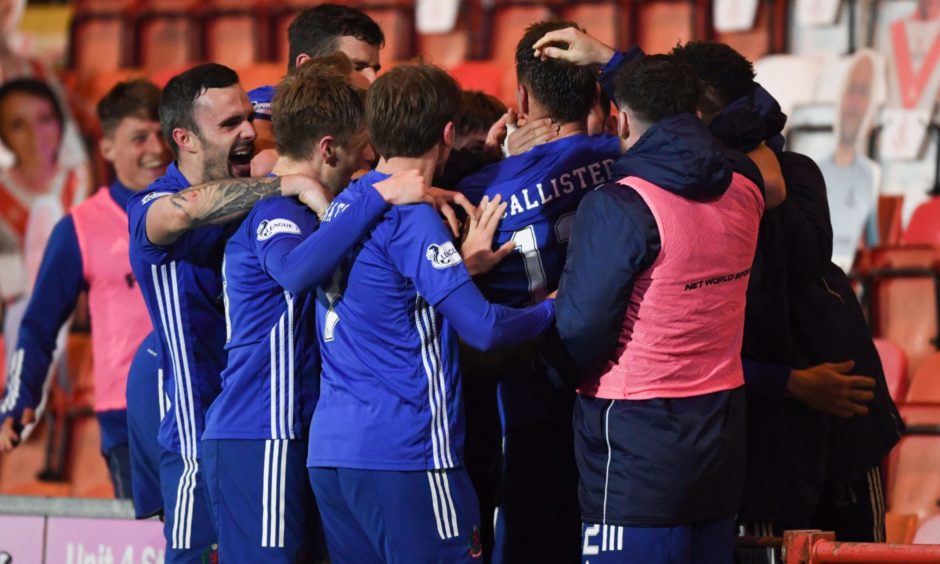 Cove's Rory McAllister (centre) celebrates making it 2-1 with his teammates.