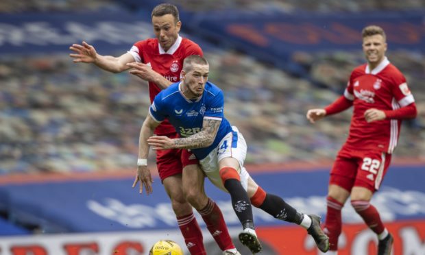 Andy Considine challenges Rangers' Ryan Kent at Ibrox