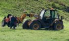 The ride-on mower being removed from the fatal accident scene. Image: Michal Wachucik/Abermedia