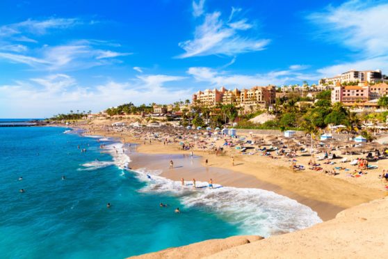 Many are starting to dream of going abroad. Image shows El Duque beach and coastline in Tenerife