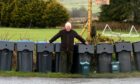 Councillor Colin Pike and some of the existing bins in use by Aberdeenshire Council's waste and recycling service.