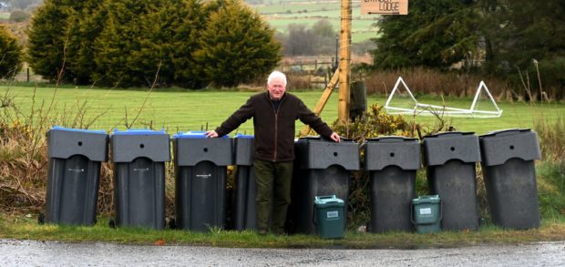 Councillor Colin Pike and some of the existing bins in use by Aberdeenshire Council's waste and recycling service.