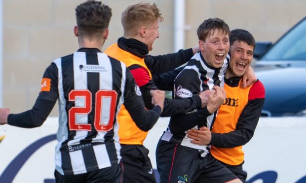 Elgin City's Kane Hester (facing) celebrates after scoring his hat-trick in the 3-2 win over Queen's Park.