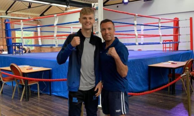 Moray boxer Fraser Wilkinson, left, with Elgin Boxing Club head coach Paul 'Ratch' Gordon