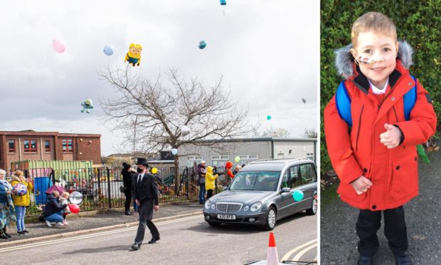 Funeral cortege passes by school.