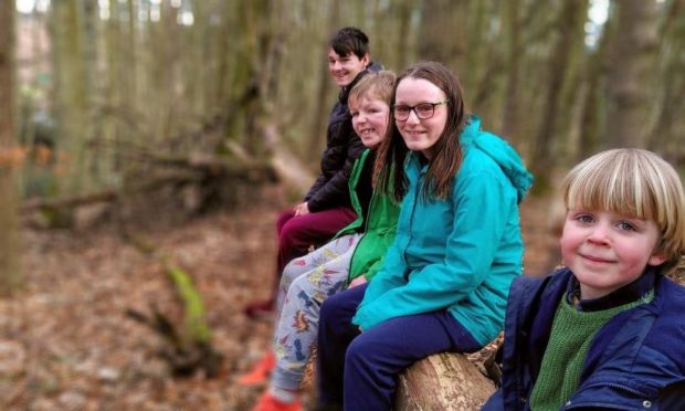 Joseph, Laurie, Tia and Joseph on one of their excursions to the woods. 