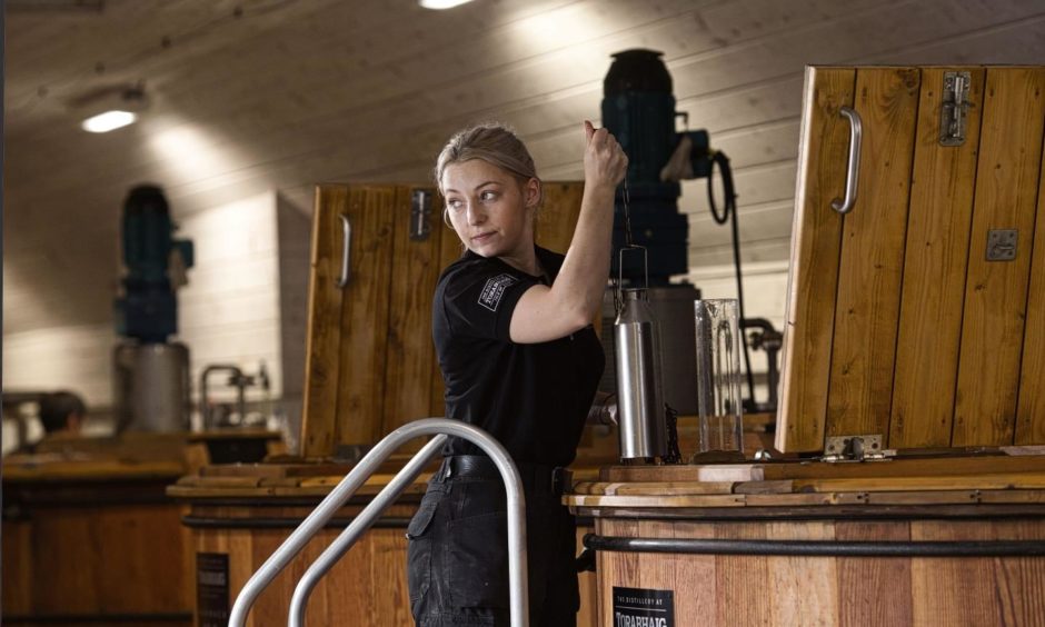 Iona Macphie working at the washback at Torabhaig.