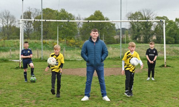 Wayne Grant, pictured centre, wants to encourage children to use the Thornhill playing fields. Also pictured: Tyler McCabe, Louie Buchan, Mitchell Grant and Jaiden Stephen. Photo by Jason Hedges.
