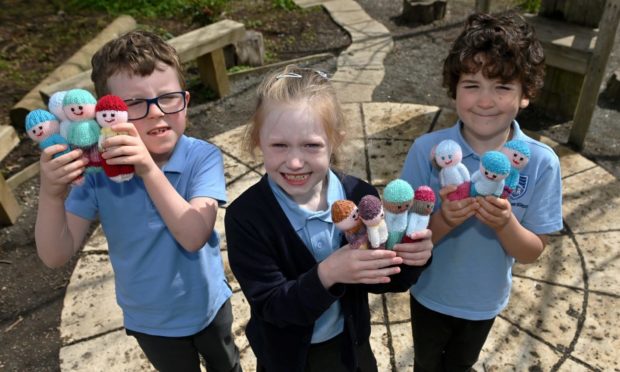 Youngsters at Inverurie’s Strathburn School are submitting a woollen worry doll for the Aberdeenshire time capsule as part of the Press and Journal and Evening Express’ scheme. Pupils Milo, Rebecca and James are pictured with their dolls.