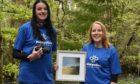 Mikeysline support worker Clare Gordon (left) and Highland artist Reina Edmiston with the prize for the competition winner.