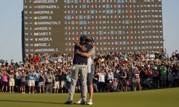 Phil Mickelson celebrates with his caddie and brother Tim after winning the final round at the PGA Championship golf tournament on the Ocean Course, Sunday, May 23, 2021, in Kiawah Island, S.C. (AP Photo/Chris Carlson)