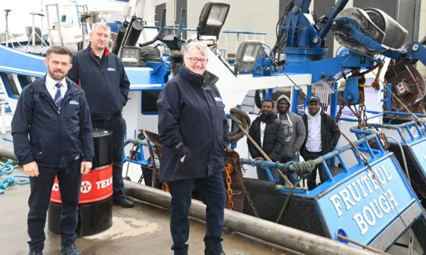 Fisherman's Mission Superintendants: Kenny Brandie, Sandy Garvock and Miriam Kemp with Ghanaian crew members from the Fruitfull Bough in Peterhead Harbour.