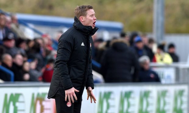 Aberdeen U18 coach Barry Robson cheers on the young Dons.