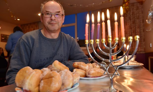 The Jewish community in Aberdeen are unable to have their Hanukkah celebration at their synagogue this year as its still closed due to flood damage.  The congregation of Summerhill Church have kindly let them use their hall this year for their festivities.
Picture of Mark Taylor (head of Aberdeen Synagogue) with the Menorah. 

Picture by KENNY ELRICK     17/12/2017