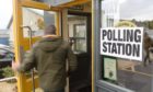 A voter enters a polling station in Inverness.