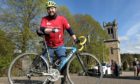 Reverend Andrew Kimmitt of Aberlour passes through the village on Saturday afternoon on the last leg of his one day run, cycle and kayak from Loch Spey to the rivers mouth at Spey Bay in aid of Christian Aid.