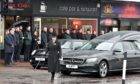 The funeral procession for Scott Dunn of The Whisky Shop in Inverness who died suddenly took place at lunchtime today through the streets of the city. Sandy McCook