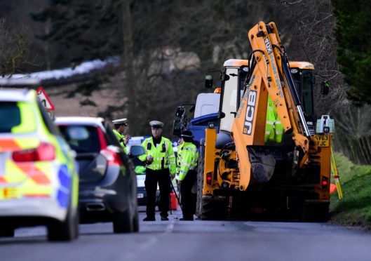 Police at the scene near the Gight junction on the B9005 Methlick to Fyvie road where William Black was working to repair flood damage.