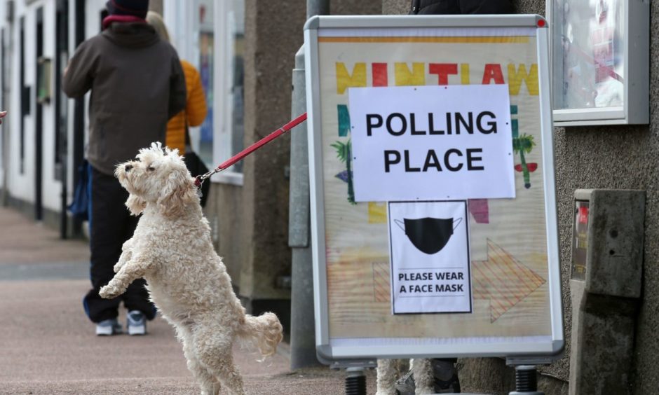 A dog waits outside a polling station in Mintlaw, Aberdeenshire. Photograph by Andrew Milligan/PA Wire