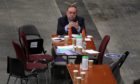 Alba party leader Alex Salmond on his phone as votes are being counted for the Scottish Parliamentary Elections at the P&J Live/TECA, Aberdeen. Picture date: Friday May 7, 2021. PA Photo. See PA story POLITICS Elections. Photo credit should read: Andrew Milligan/PA Wire