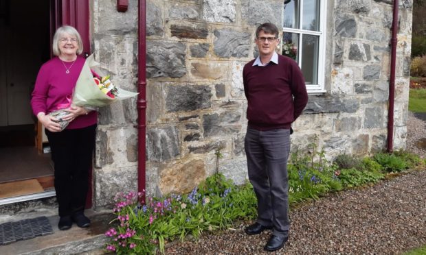 Morag Macleod receives a bunch of flowers from David Duff on her retirement.