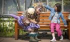 Lilia Barbirou, aged eight, meets "The Undiscovered Creature" during a performance in the Royal Botanic Garden Edinburgh.
