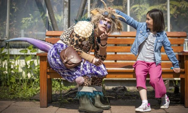Lilia Barbirou, aged eight, meets "The Undiscovered Creature" during a performance in the Royal Botanic Garden Edinburgh.