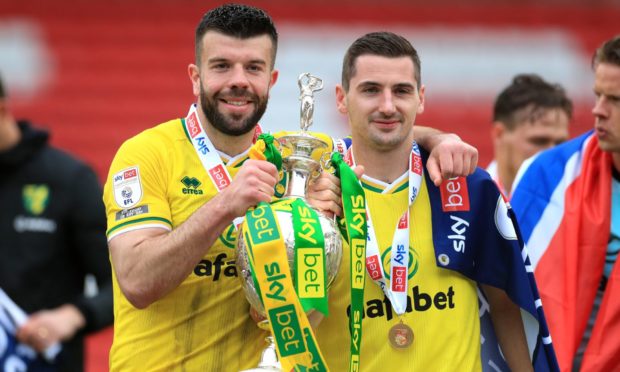 Norwich City's Scotland pair Grant Hanley (left) and Kenny McLean pose with the Championship trophy.