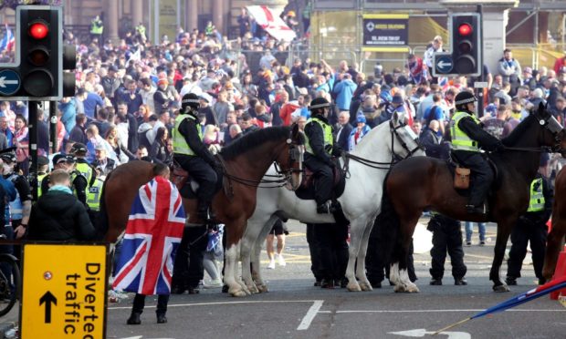 Mounted police watch on as Rangers fans celebrate winning the Scottish Premiership in George Square, Glasgow, after their match against Aberdeen. Picture date: Saturday May 15, 2021. PA Photo. See PA story SOCCER Rangers. Photo credit should read: Andrew Milligan/PA Wire.
