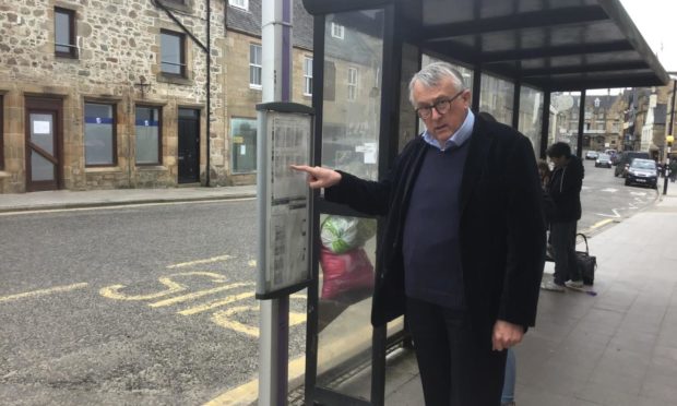 Jamie Stone MP at a bus stop on Tain High Street. Mr Stone has highlighted the difficulties faced by bus users in the Highlands.