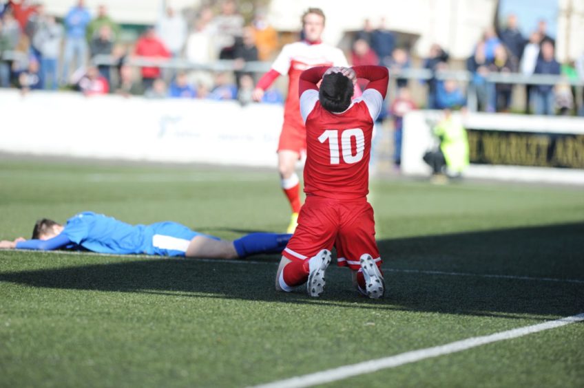 Brora player Steven Mackay realises he is going to be sent off.