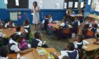 A teacher and her class at a primary school in Jamaica.